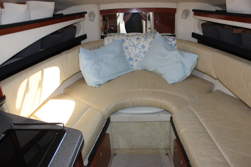 Slide: The Image of Interior cabin of 2006 Sea Ray Sundancer 260 with beige seating and cushions. - 25