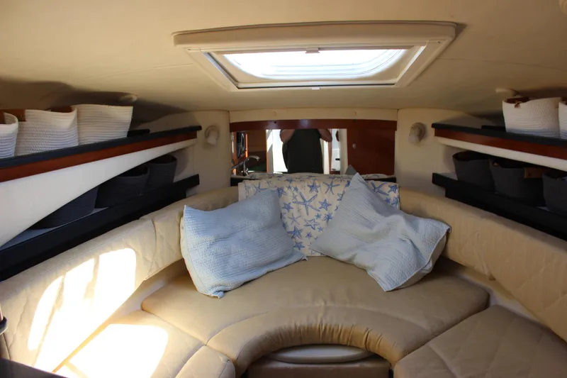 Slide: The Image of Interior cabin of 2006 Sea Ray Sundancer 260 with cozy seating and cushions. - 26