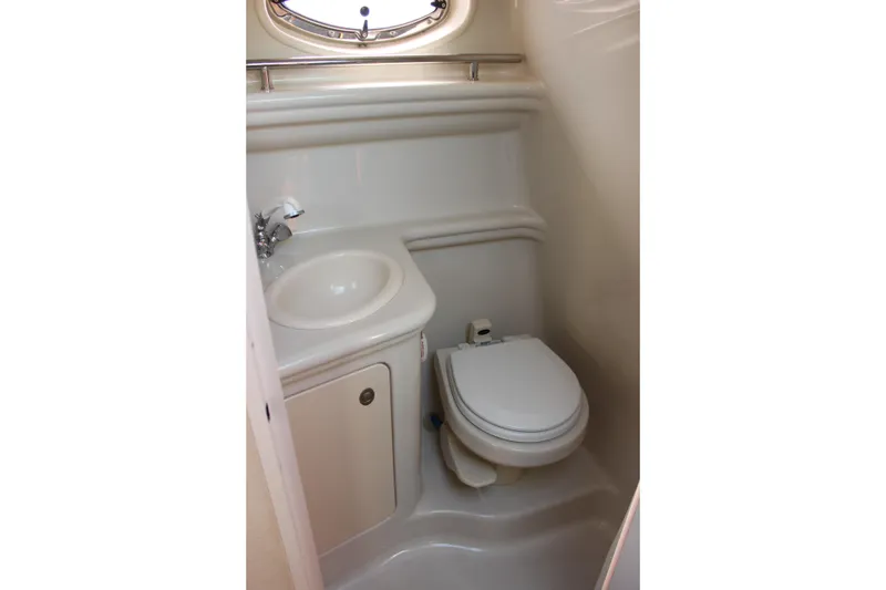 Slide: The Image of Compact bathroom in 2006 Sea Ray Sundancer 260 boat, featuring toilet and sink. - 29