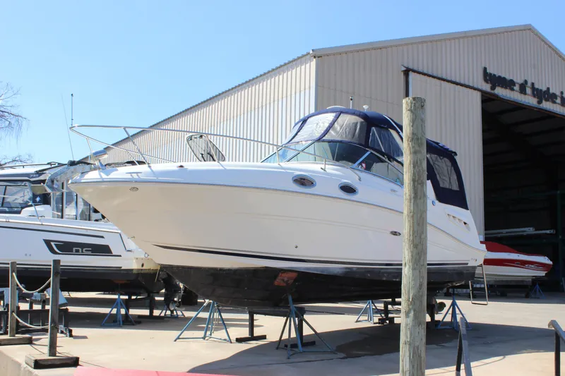 Slide: The Image of 2006 Sea Ray Sundancer 260 boat on stands outside a storage facility. - 4