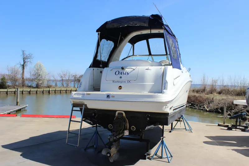 Slide: The Image of 2006 Sea Ray Sundancer 260 boat on stands by a riverside dock. - 6
