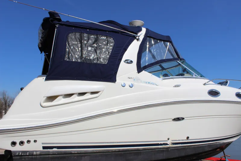 Slide: The Image of 2006 Sea Ray Sundancer 260 boat with blue canopy against clear sky. - 8