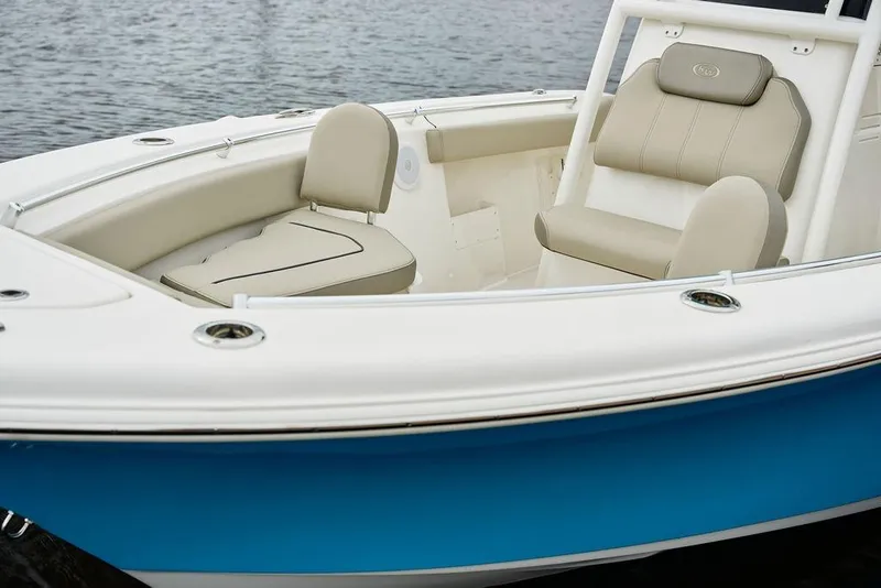 Slide: The Image of 2026 Key West 239 FS boat with beige seating and blue hull on water. - 4