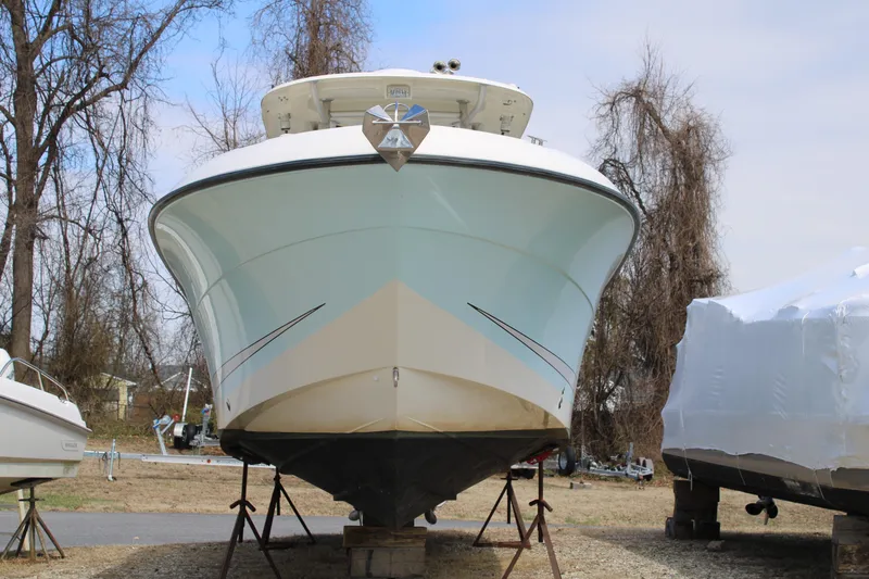 Slide: The Image of 2007 Hydra-Sports Vector 2900 CC boat on stands, surrounded by trees and covered boats. - 2