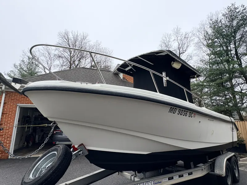 Slide: The Image of 1999 Boston Whaler 230 Outrage on trailer, side view. - 12