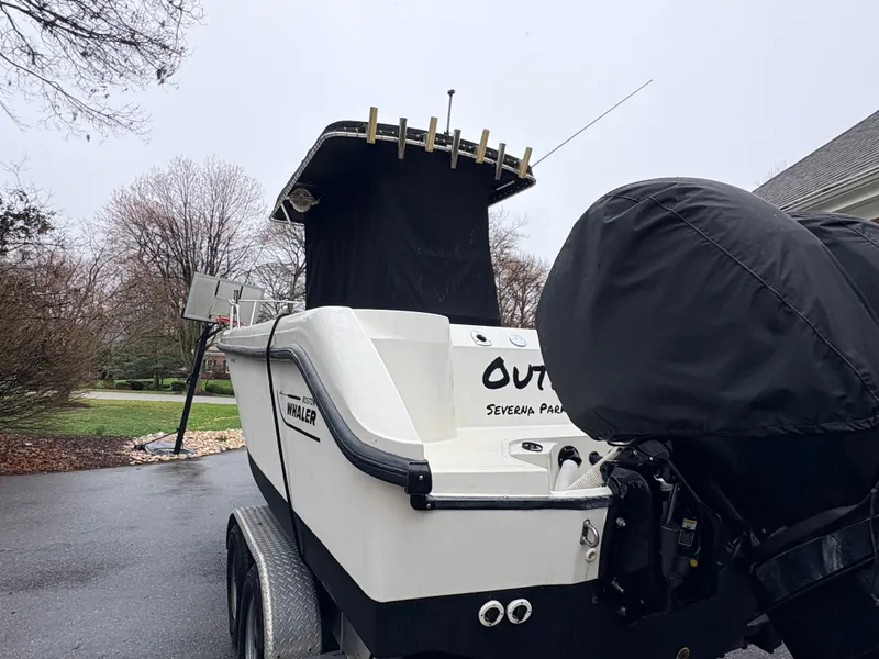 Slide: The Image of 1999 Boston Whaler 230 Outrage boat parked outdoors on trailer. - 13