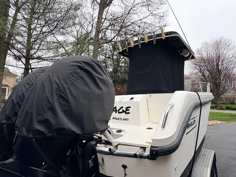 Slide: The Image of 1999 Boston Whaler 230 Outrage boat parked outdoors. - 15