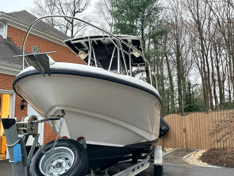 Slide: The Image of 1999 Boston Whaler 230 Outrage on trailer in driveway. - 3