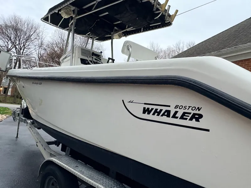 Slide: The Image of 1999 Boston Whaler 230 Outrage on trailer, side view. - 4