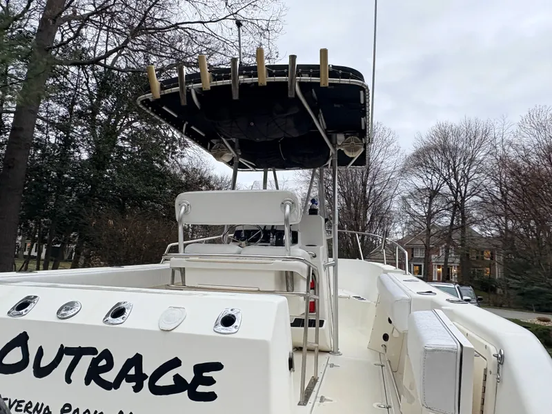 Slide: The Image of 1999 Boston Whaler 230 Outrage boat with T-top and seating area. - 6