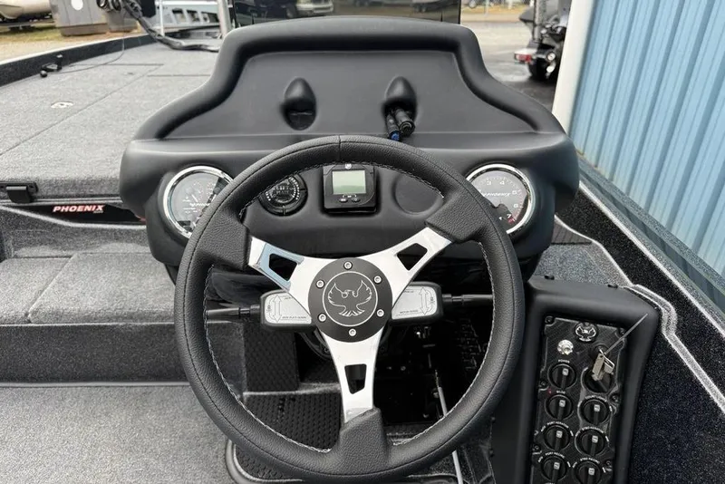 Slide: The Image of Steering console of 2026 Phoenix 721 ZXL boat with gauges and controls. - 13