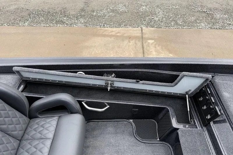 Slide: The Image of Interior of 2026 Phoenix 721 ZXL boat with open storage compartment and quilted seat. - 14