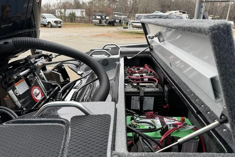 Slide: The Image of Open battery compartment of 2026 Phoenix 721 ZXL boat, showing wiring and components. - 19