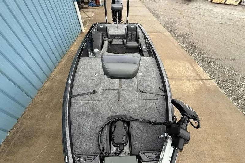 Slide: The Image of 2026 Phoenix 721 ZXL fishing boat with gray interior, docked beside a blue building. - 25