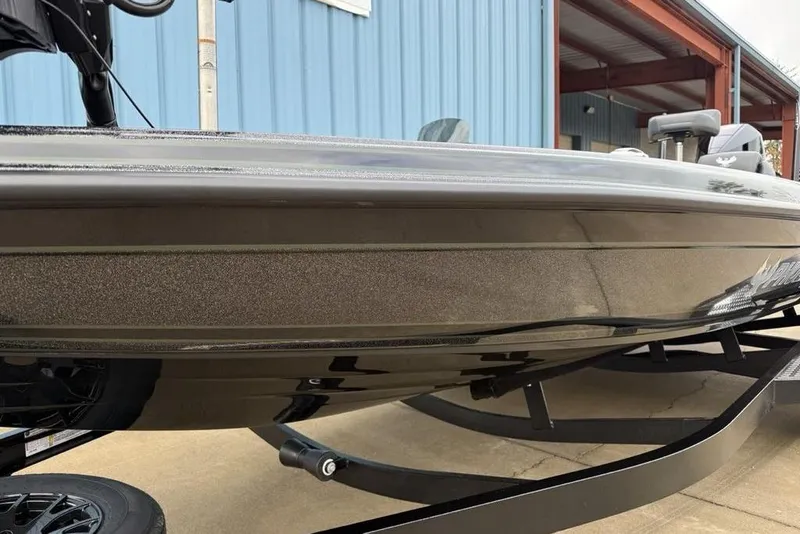 Slide: The Image of 2026 Phoenix 721 ZXL boat on trailer near blue building. - 4