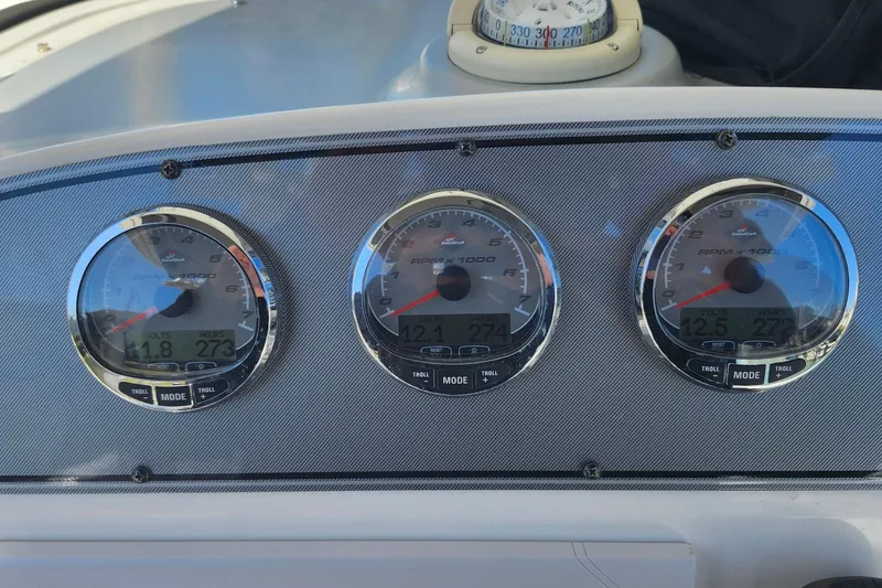 Slide: The Image of Dashboard of a 2014 Wellcraft 35 Scarab Sport boat with three gauges. - 10