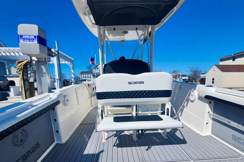 Slide: The Image of 2014 Wellcraft 35 Scarab Sport boat interior with seating and deck view. - 14