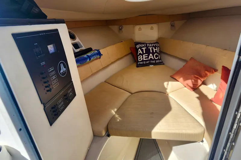 Slide: The Image of Cozy cabin interior of 2014 Wellcraft 35 Scarab Sport with cushions and control panel. - 17
