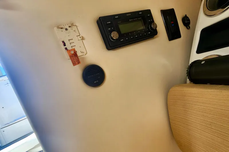 Slide: The Image of 2014 Wellcraft 35 Scarab Sport interior with stereo system and control panel. - 18