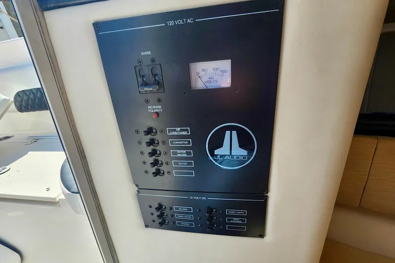 Slide: The Image of Control panel on 2014 Wellcraft 35 Scarab Sport boat featuring JL Audio system. - 19