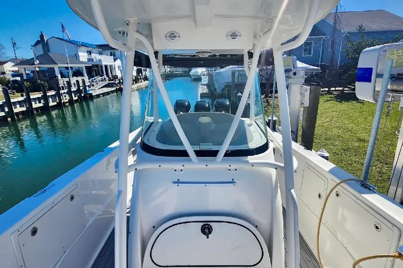 Slide: The Image of 2014 Wellcraft 35 Scarab Sport boat docked by waterfront homes. - 21