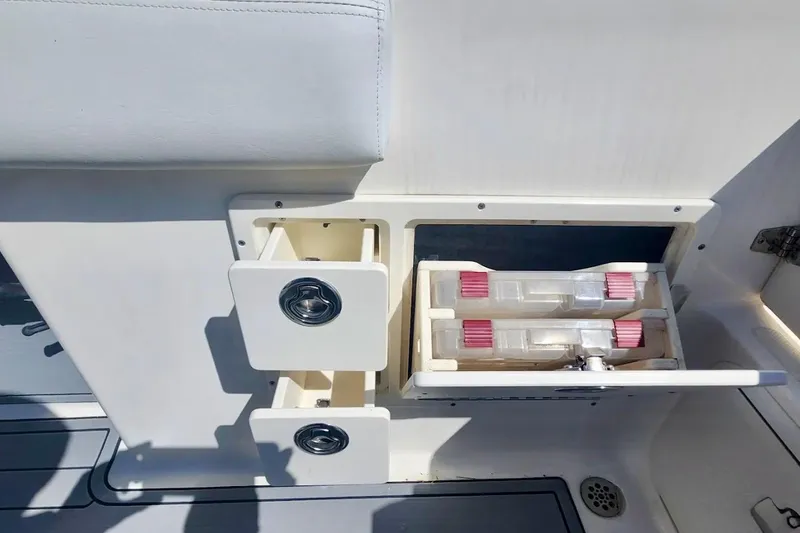 Slide: The Image of Storage compartments on a 2014 Wellcraft 35 Scarab Sport boat interior. - 24
