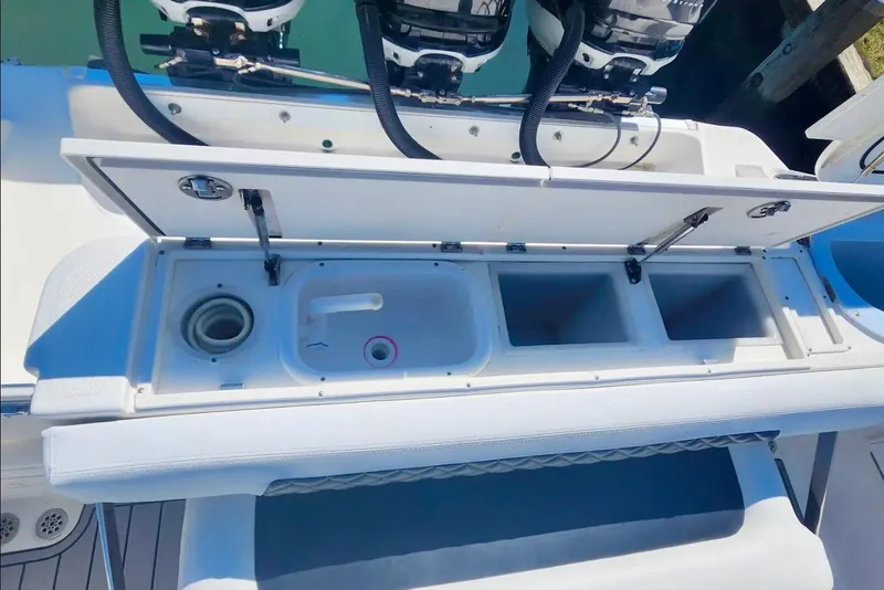 Slide: The Image of Open storage compartments on a 2014 Wellcraft 35 Scarab Sport boat, showcasing utility features. - 25