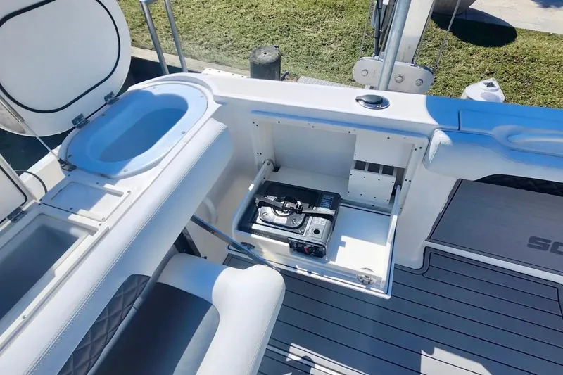 Slide: The Image of 2014 Wellcraft 35 Scarab Sport boat interior with storage compartment and seating. - 27
