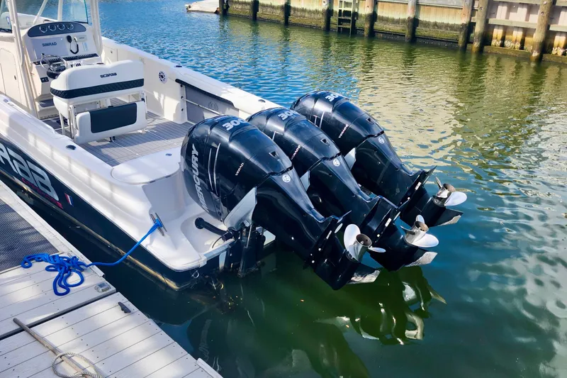 Slide: The Image of 2014 Wellcraft 35 Scarab Sport boat with triple Mercury outboard engines docked. - 3