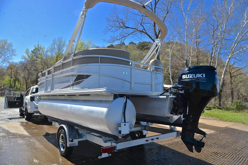 Slide: The Image of 2023 Starcraft EX 18 F pontoon boat on trailer with Suzuki outboard motor. - 12