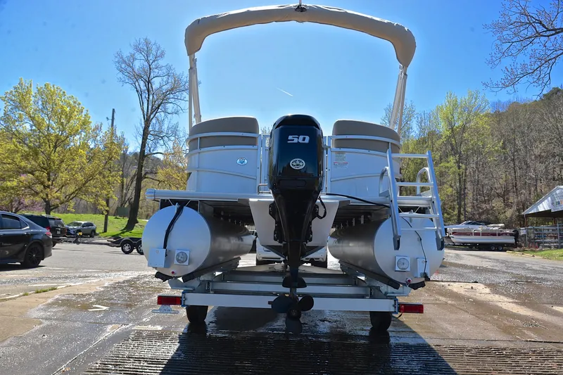 Slide: The Image of 2023 Starcraft EX 18 F pontoon boat on trailer, rear view, outdoors. - 13