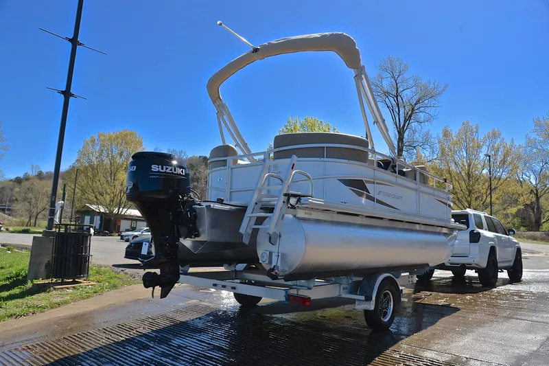 Slide: The Image of 2023 Starcraft EX 18 F pontoon boat on trailer with Suzuki outboard motor. - 14