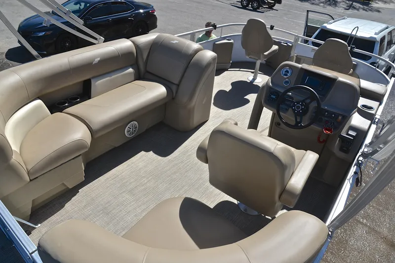 Slide: The Image of 2023 Starcraft EX 18 F boat interior with beige seating and steering console. - 19