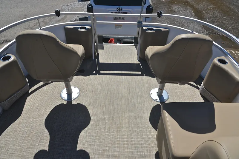 Slide: The Image of 2023 Starcraft EX 18 F boat interior with beige seating and cup holders. - 21