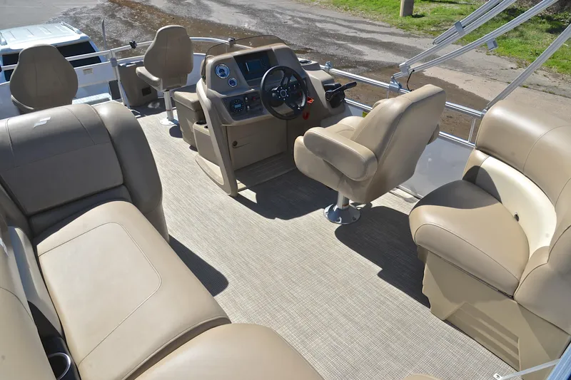 Slide: The Image of 2023 Starcraft EX 18 F boat interior with beige seating and steering console. - 23
