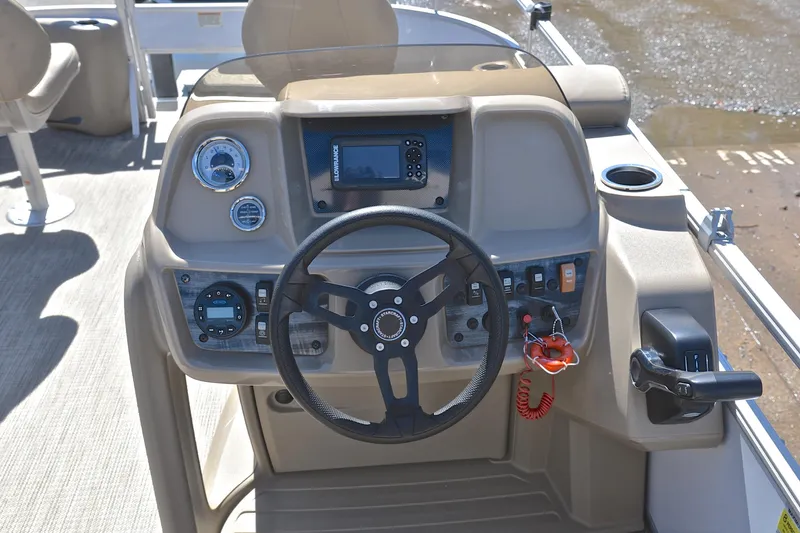 Slide: The Image of 2023 Starcraft EX 18 F boat dashboard with steering wheel and control panel. - 24