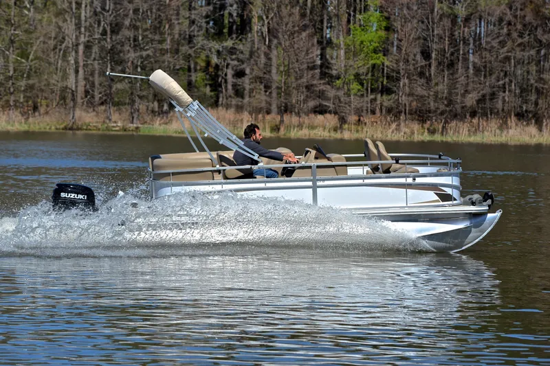 Slide: The Image of 2023 Starcraft EX 18 F pontoon boat cruising on a lake with Suzuki outboard motor. - 3