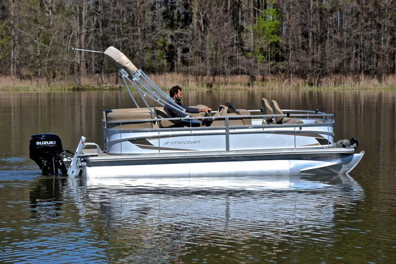 Slide: The Image of 2023 Starcraft EX 18 F pontoon boat on a calm lake. - 6