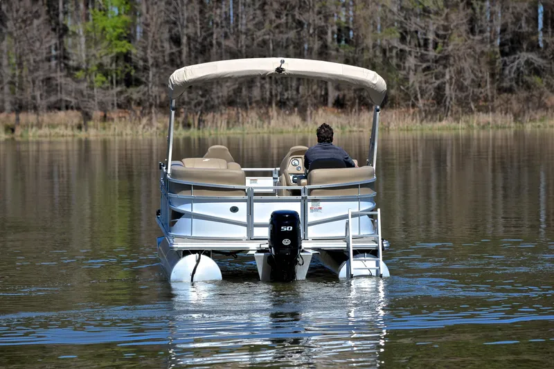 Slide: The Image of 2023 Starcraft EX 18 F pontoon boat on a calm lake. - 7