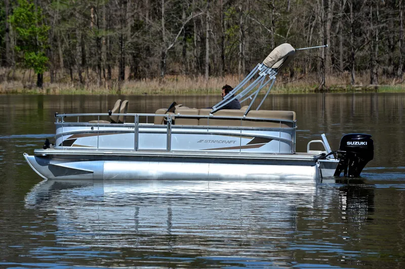 Slide: The Image of 2023 Starcraft EX 18 F pontoon boat on a calm lake. - 8