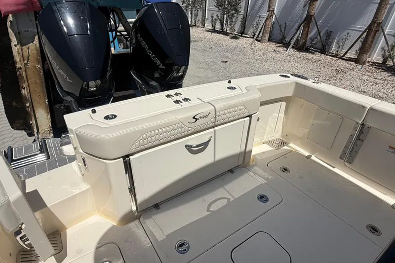 Slide: The Image of 2026 Scout 288 LXF boat deck with dual Mercury outboard engines. - 11
