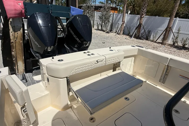 Slide: The Image of 2026 Scout 288 LXF boat with dual Mercury engines and foldable seating. - 12
