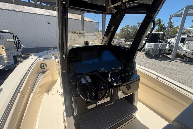 Slide: The Image of 2026 Scout 288 LXF boat cockpit with steering wheel and control panel. - 23