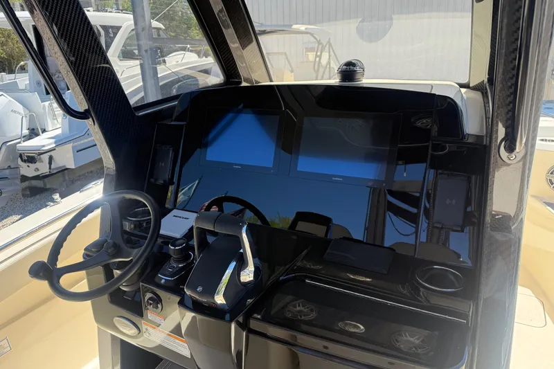 Slide: The Image of 2026 Scout 288 LXF boat dashboard with steering wheel and digital displays. - 29