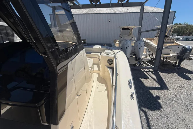 Slide: The Image of 2026 Scout 288 LXF boat docked, showcasing sleek design and modern features. - 30