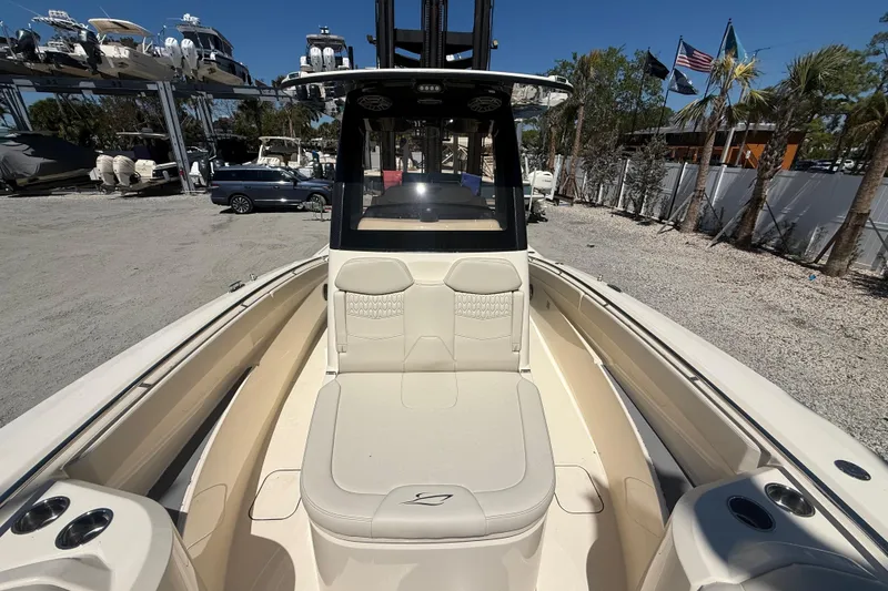 Slide: The Image of 2026 Scout 288 LXF boat interior with seating, cup holders, and helm station. - 33