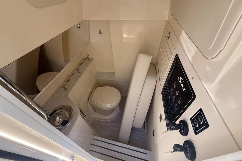 Slide: The Image of 2026 Scout 288 LXF boat interior with compact bathroom and control panel. - 34