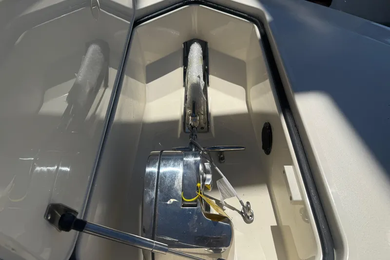 Slide: The Image of Anchor compartment of 2026 Scout 288 LXF boat, featuring stainless steel hardware. - 35
