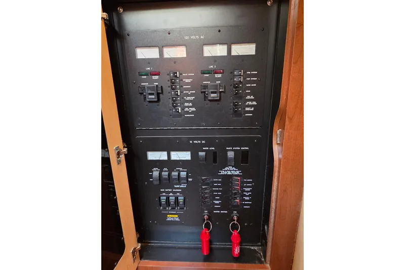 Slide: The Image of Electrical panel of a 2007 Sea Ray 40 Sundancer boat, featuring switches and gauges. - 14