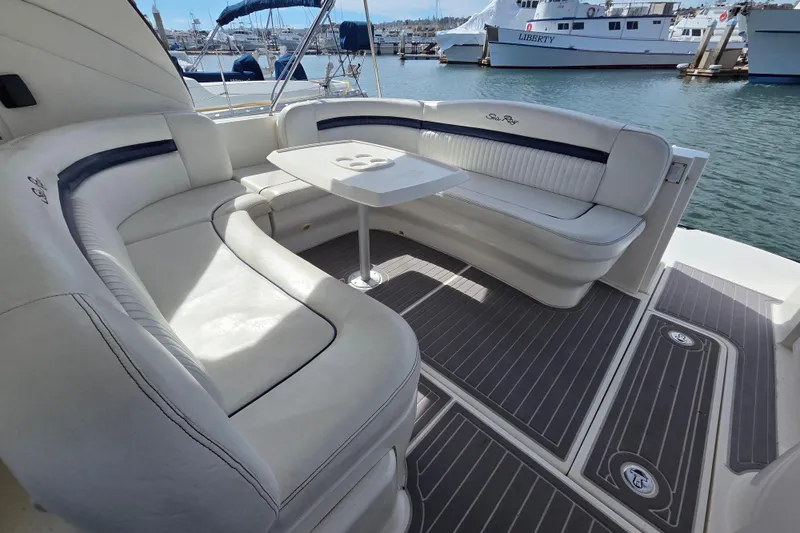 Slide: The Image of Luxurious seating area on a 2007 Sea Ray 40 Sundancer yacht, docked at a marina. - 17